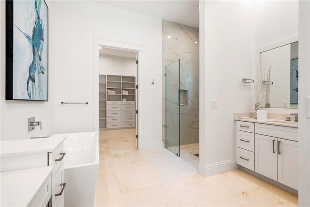 10 Strand Dr, Vero Beach, FL 32963 - bathroom with a marble finish shower, a walk in closet, vanity, a tub to relax in, and marble finish flooring