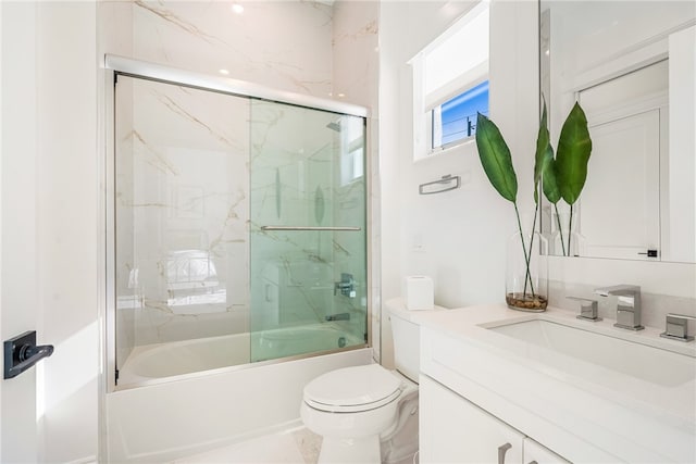 full bathroom featuring toilet, vanity, and enclosed tub / shower combo