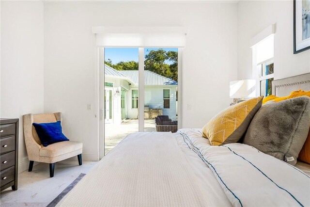 10 Strand Dr, Vero Beach, FL 32963 - bedroom featuring access to outside, multiple windows, and baseboards