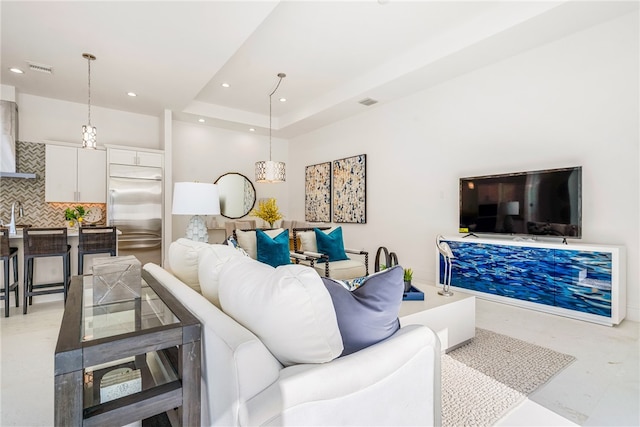 living room featuring a tray ceiling