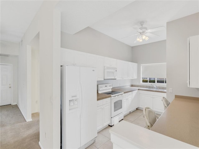 kitchen featuring white cabinetry, sink, ceiling fan, white appliances, and light tile patterned floors