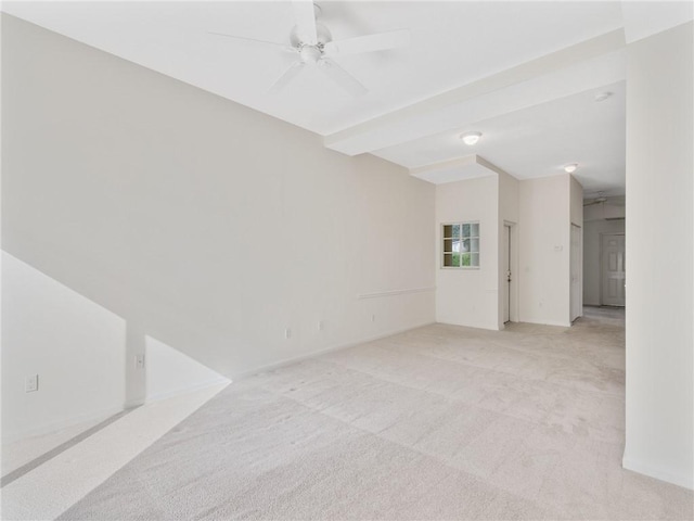 carpeted spare room with lofted ceiling with beams and ceiling fan