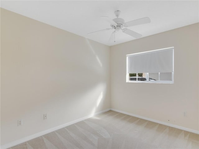 spare room featuring carpet and ceiling fan