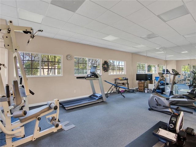 exercise room with a paneled ceiling and carpet floors