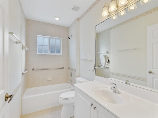 full bathroom featuring tile patterned flooring, vanity, tiled shower / bath combo, and toilet