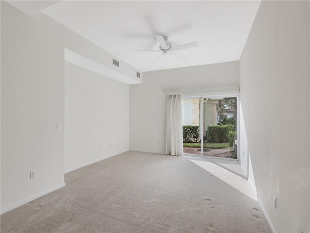 carpeted spare room featuring ceiling fan