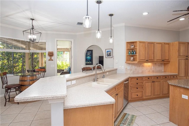 kitchen with pendant lighting, sink, tasteful backsplash, light tile patterned flooring, and stainless steel dishwasher