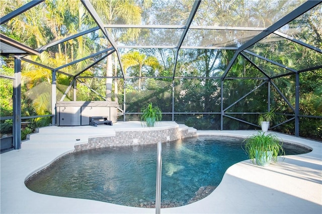 view of swimming pool with a patio area, pool water feature, and glass enclosure