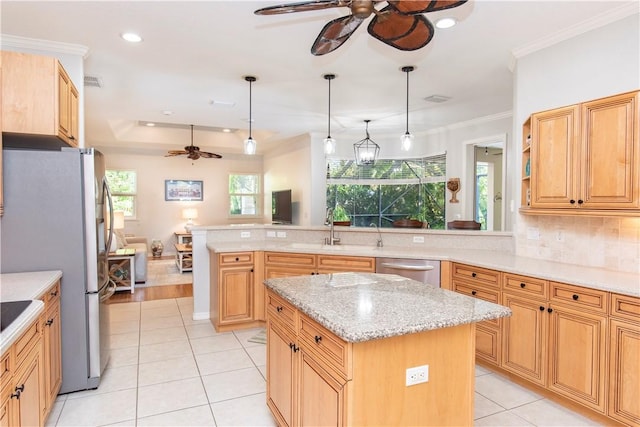 kitchen featuring appliances with stainless steel finishes, pendant lighting, a center island, light stone counters, and crown molding