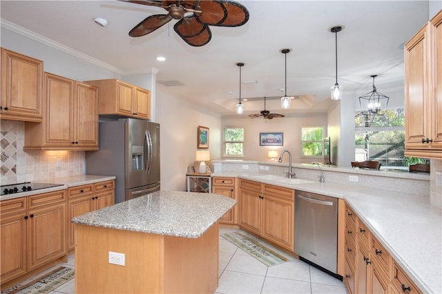 kitchen featuring pendant lighting, sink, crown molding, appliances with stainless steel finishes, and a kitchen island