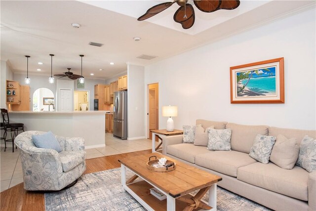 kitchen with pendant lighting, sink, light tile patterned floors, crown molding, and backsplash