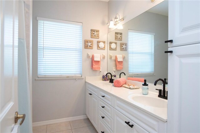 laundry room featuring cabinets, washing machine and dryer, and light tile patterned flooring