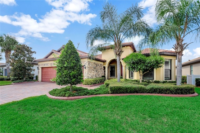 view of front of house with a front yard and a garage