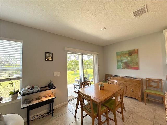 4173 Keeson Cir, Vero Beach, FL 32967 - dining room featuring a textured ceiling and light tile patterned floors