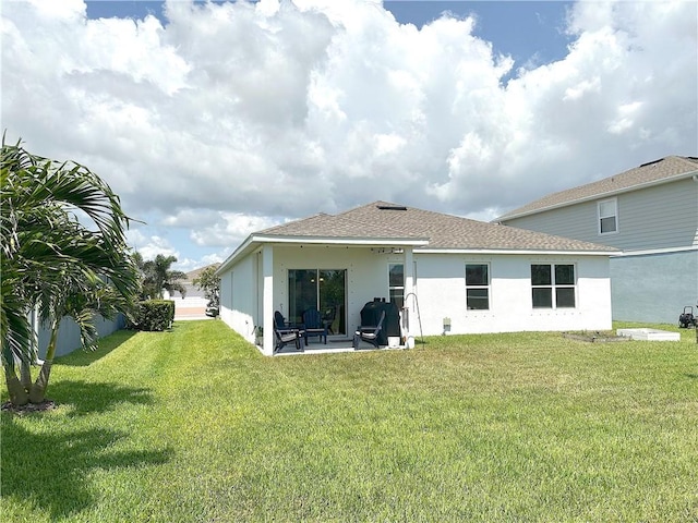 4173 Keeson Cir, Vero Beach, FL 32967 - back of property featuring stucco siding, a lawn, and roof with shingles