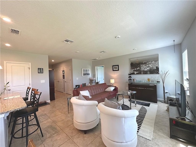 4173 Keeson Cir, Vero Beach, FL 32967 - living room featuring recessed lighting, light tile patterned floors, and a textured ceiling