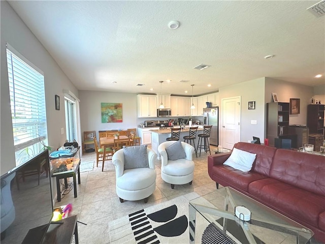 4173 Keeson Cir, Vero Beach, FL 32967 - living area featuring recessed lighting, light tile patterned floors, and a textured ceiling