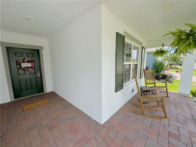 4173 Keeson Cir, Vero Beach, FL 32967 - view of exterior entry with a porch and stucco siding