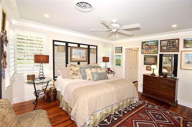 bedroom featuring ornamental molding, dark hardwood / wood-style floors, ceiling fan, and a closet