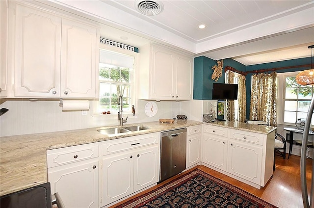 kitchen with white cabinetry, sink, and dishwasher