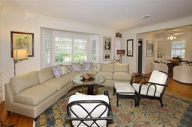 living room with ceiling fan, ornamental molding, and hardwood / wood-style floors