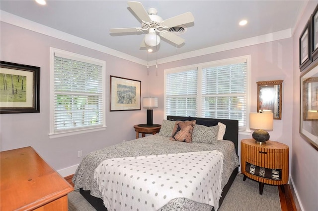 bedroom with hardwood / wood-style flooring, ceiling fan, and ornamental molding