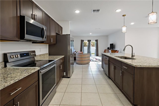 8646 102nd Ave, Vero Beach, FL 32967 - kitchen featuring appliances with stainless steel finishes, a sink, dark brown cabinetry, pendant lighting, and recessed lighting