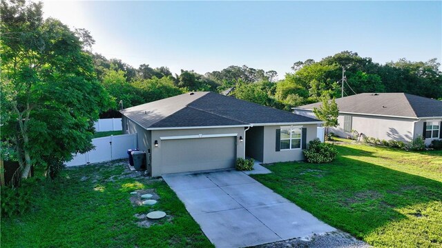 8646 102nd Ave, Vero Beach, FL 32967 - ranch-style home featuring a garage, stucco siding, concrete driveway, and a shingled roof