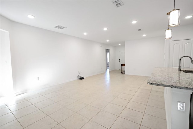 8646 102nd Ave, Vero Beach, FL 32967 - kitchen featuring a sink, recessed lighting, light stone counters, hanging light fixtures, and light tile patterned floors