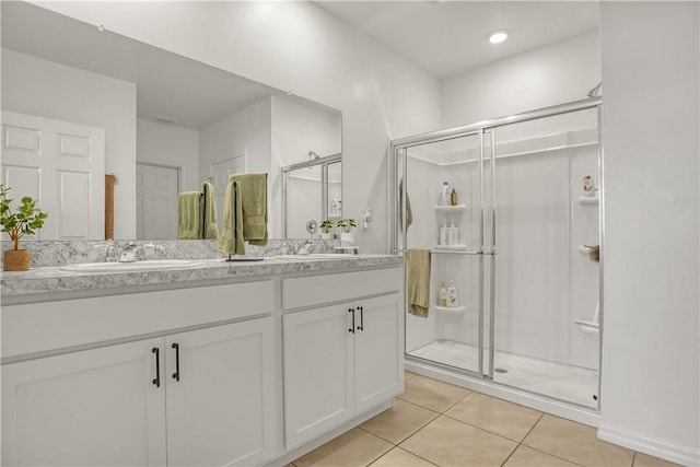 bathroom with an enclosed shower, vanity, and tile patterned floors