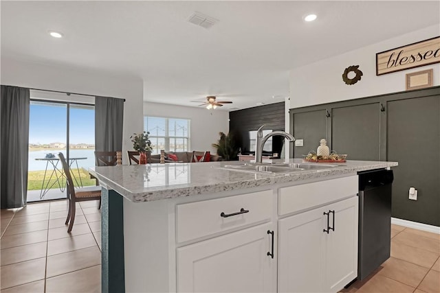 kitchen featuring sink, a water view, white cabinetry, dishwashing machine, and a kitchen island with sink