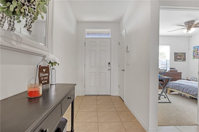 tiled entryway featuring ceiling fan