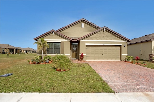 view of front of home featuring a garage and a front lawn