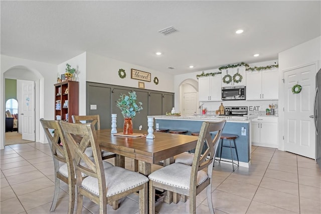 tiled dining room with sink