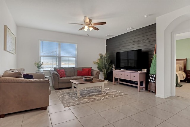 living room featuring light tile patterned flooring and ceiling fan