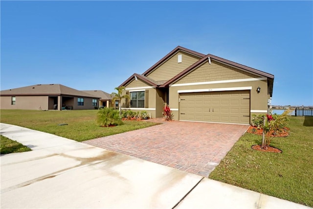 view of front of property with a garage and a front lawn