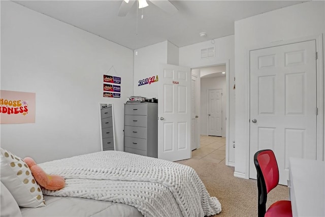 bedroom featuring ceiling fan and light carpet