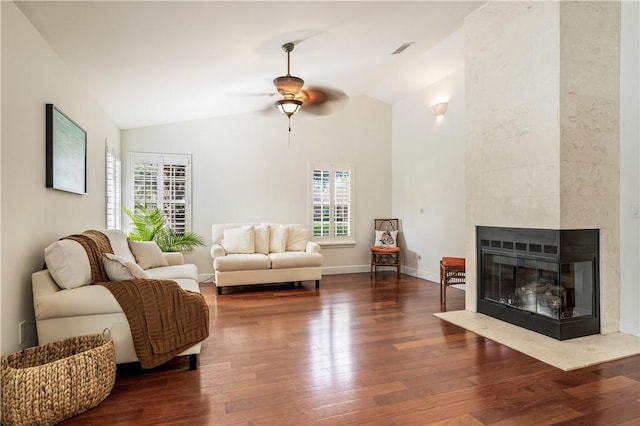 living room featuring a fireplace, dark wood-type flooring, high vaulted ceiling, and ceiling fan