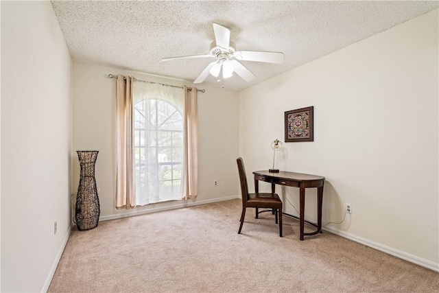 office featuring ceiling fan, light carpet, and a textured ceiling