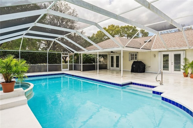 view of pool with french doors, a grill, ceiling fan, a patio, and a lanai