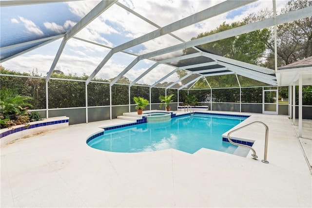 view of swimming pool with an in ground hot tub, a lanai, and a patio area