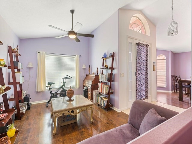 living room with dark hardwood / wood-style floors, vaulted ceiling, and ceiling fan