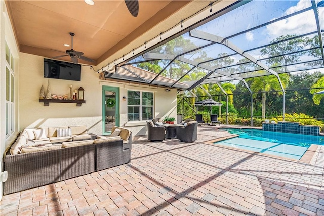 view of patio with an outdoor living space, a ceiling fan, an outdoor pool, and a lanai