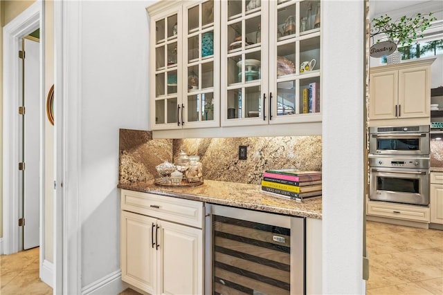 bar featuring light tile patterned floors, decorative backsplash, a bar, wine cooler, and double oven