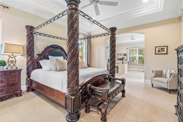 bedroom featuring baseboards, carpet floors, a tray ceiling, ceiling fan, and ornamental molding