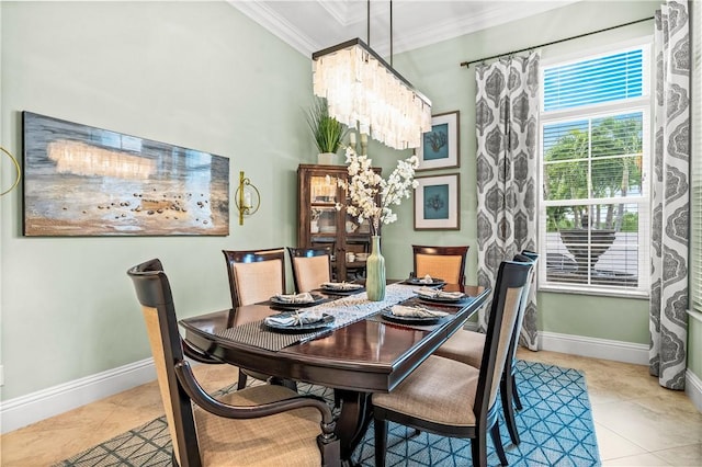 dining room with an inviting chandelier, crown molding, baseboards, and tile patterned floors