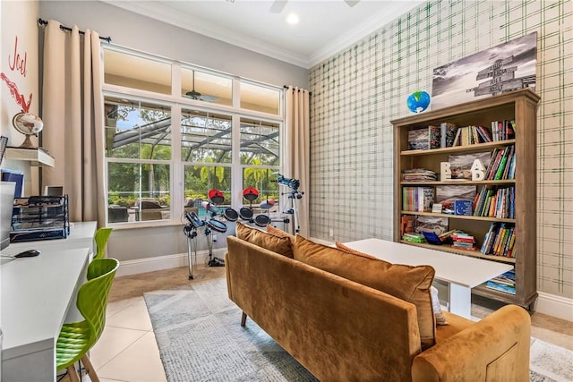 living area featuring tile patterned flooring, wallpapered walls, crown molding, baseboards, and ceiling fan