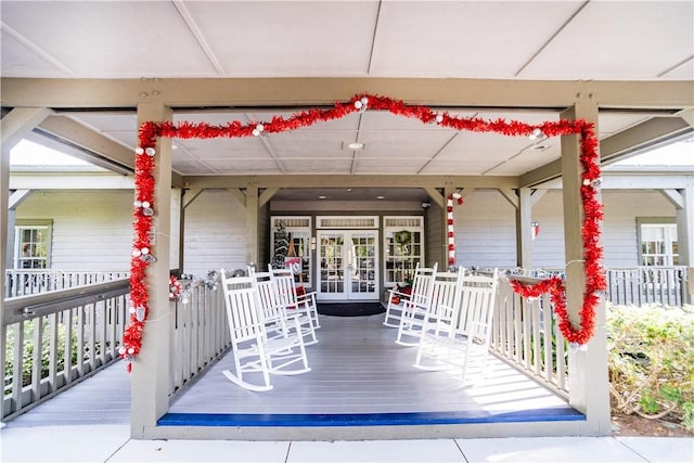 wooden terrace with covered porch and french doors