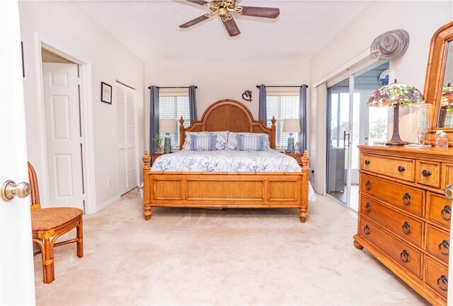 bedroom featuring access to exterior, multiple windows, and light colored carpet