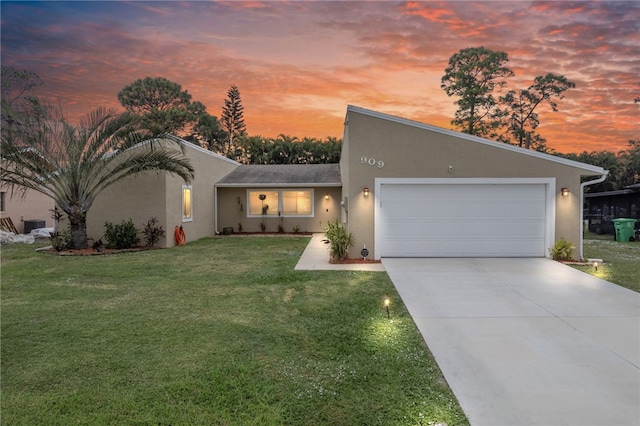 view of front of home featuring a garage and a yard